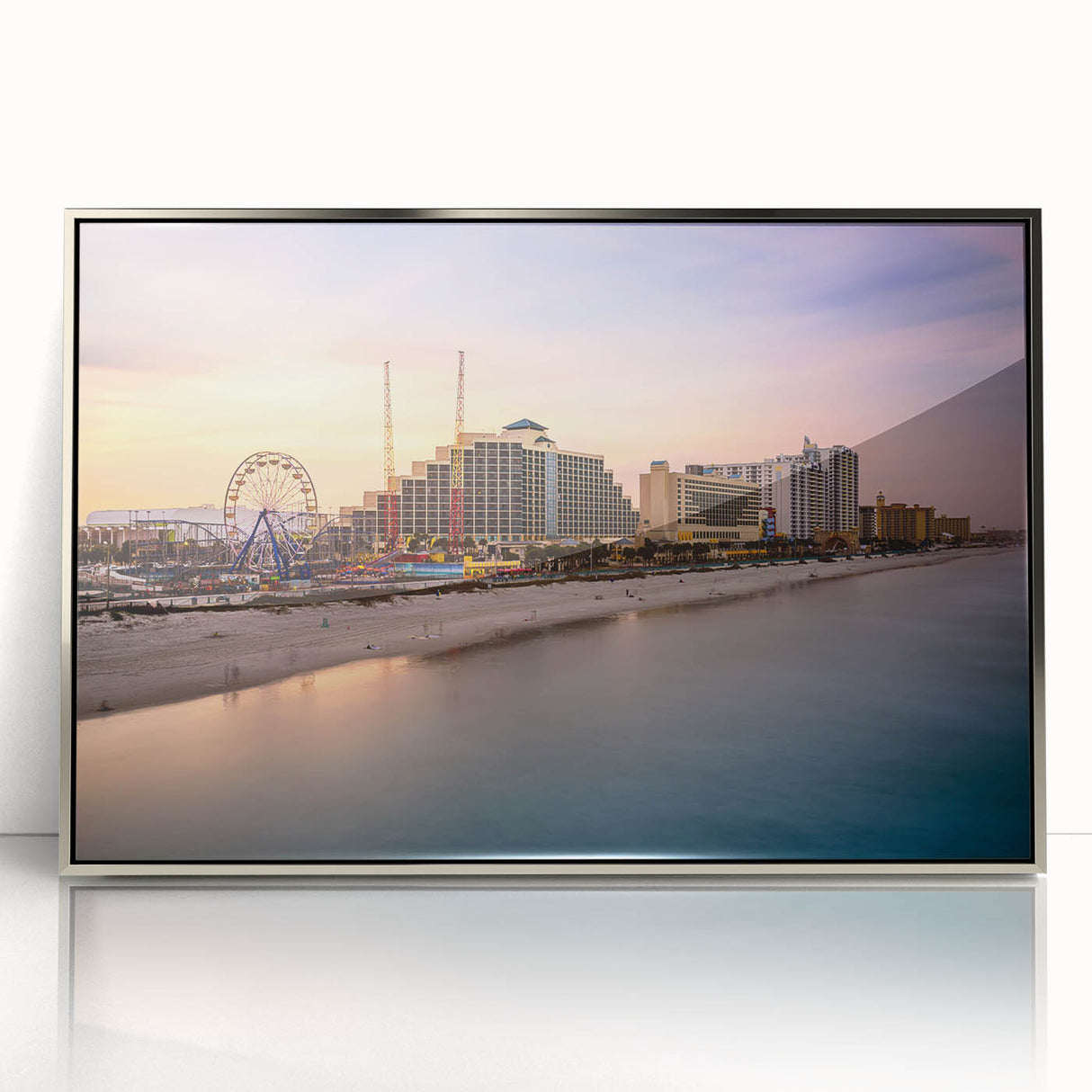 Mid-century modernist art depicting Daytona beach scenery in muted blue and beige tones, framed in silver acrylic.