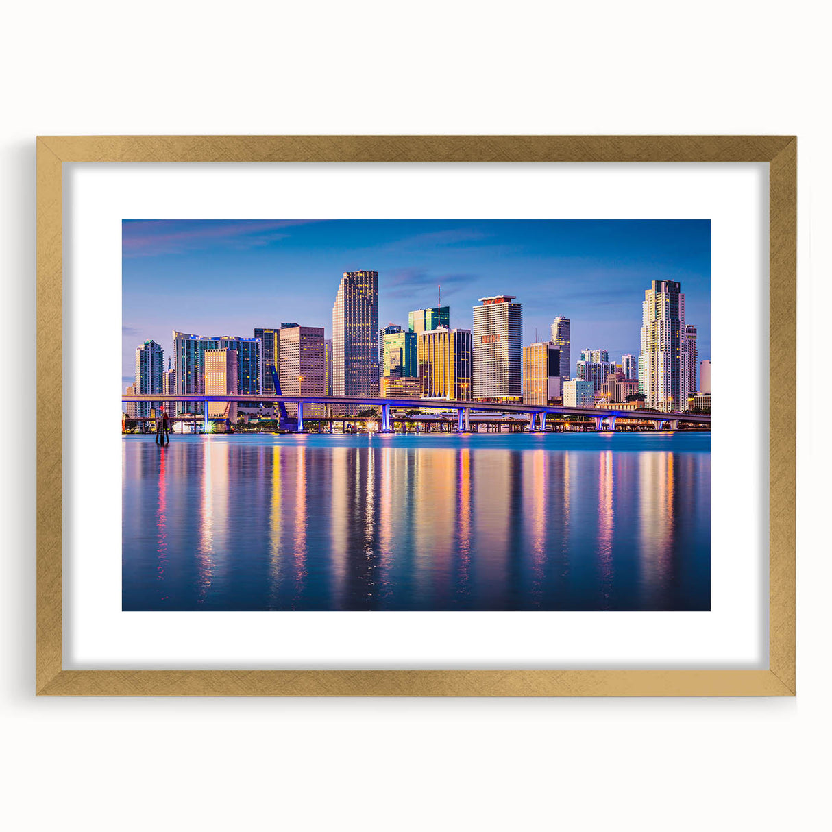 Extra large abstract art print of Miami skyline in vibrant twilight hues on a textured canvas, framed in gold.