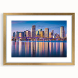 Extra large abstract art print of Miami skyline in vibrant twilight hues on a textured canvas, framed in gold.