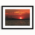 Colorful abstract art print of Annapolis scenery in vibrant hues on a black framed mat, ideal for living room decor.