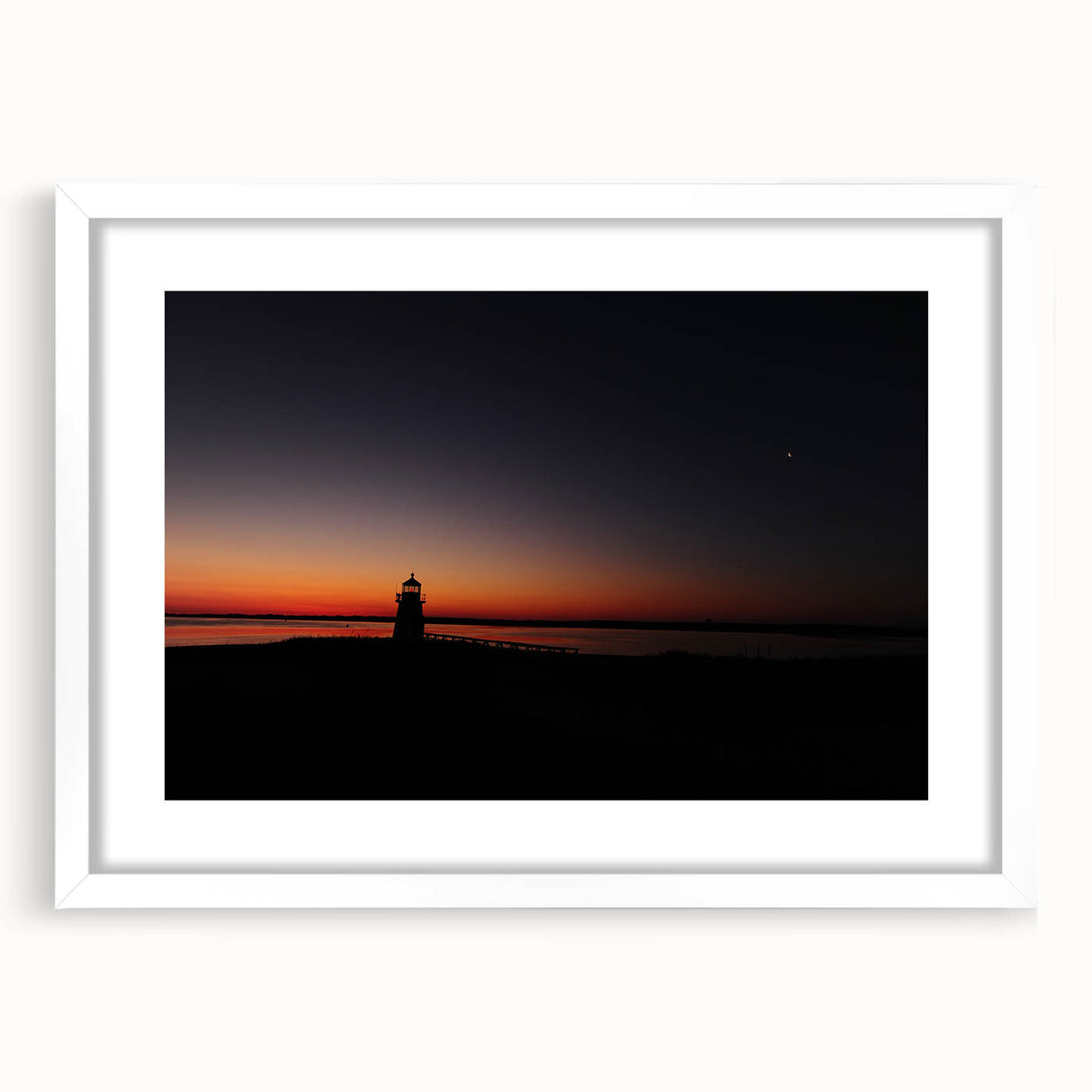 Abstract art print of Nantucket scenery in muted blue and white tones, framed in white, suitable for dining room decor.