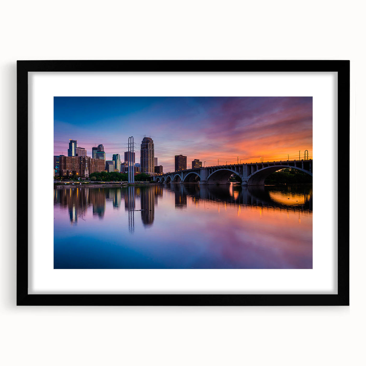 Extra large abstract art print of Minneapolis skyline in colorful, textured hues on a black framed canvas.