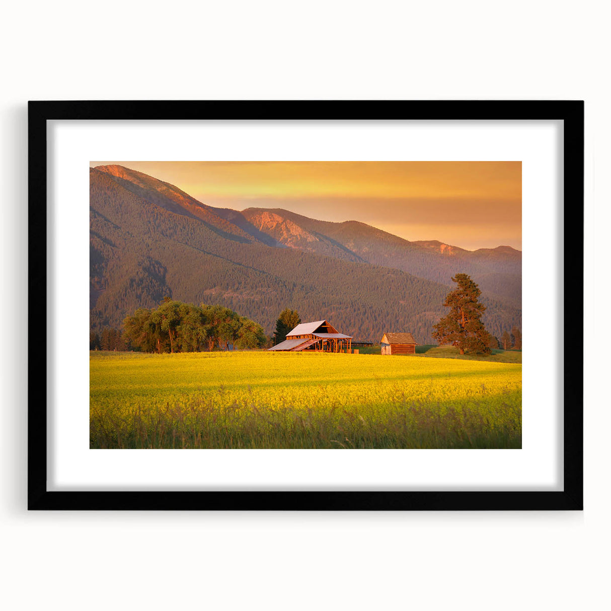 Abstract art print featuring textured, colorful art of Montana scenery in a large black frame, ideal for living room decor.