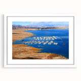 Abstract art print of Lake Mead in muted blue and green tones on a white framed mat, ideal for dining room decor.