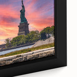 Black wall art featuring a textured depiction of Ellis Island, with colorful accents, framed on canvas.