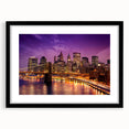 Extra large abstract art print of Manhattan skyline in vibrant colors on a textured canvas, framed in black.