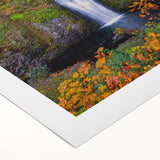 Art deco poster of Multnomah Falls in Oregon, featuring vibrant green and blue tones on rolled canvas.