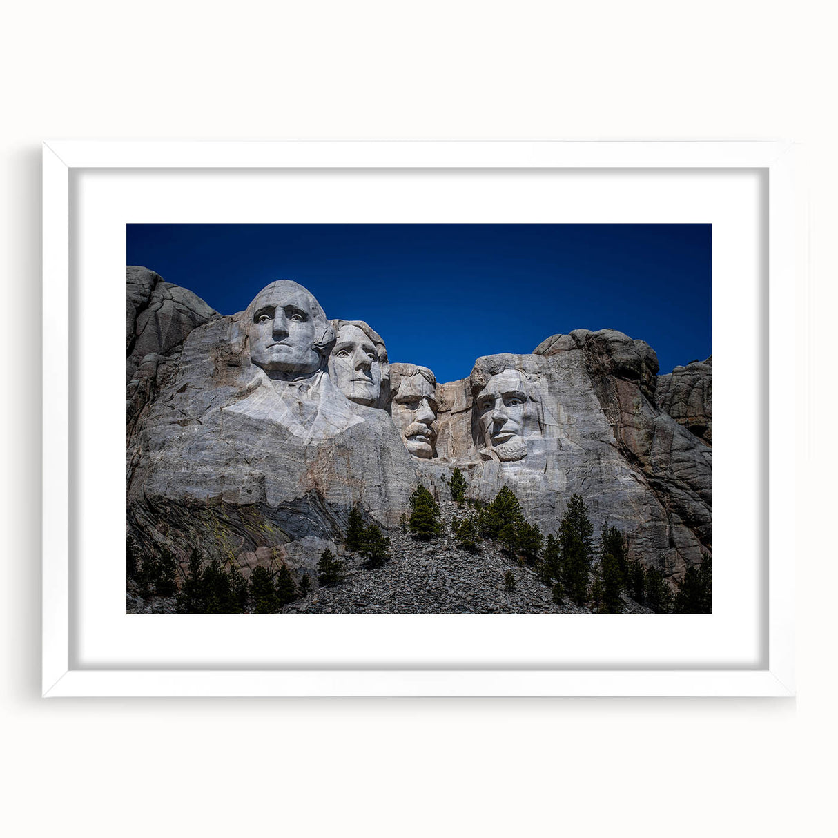 Abstract art print of Mt. Rushmore in muted earth tones on a framed white mat, suitable for dining room decor.