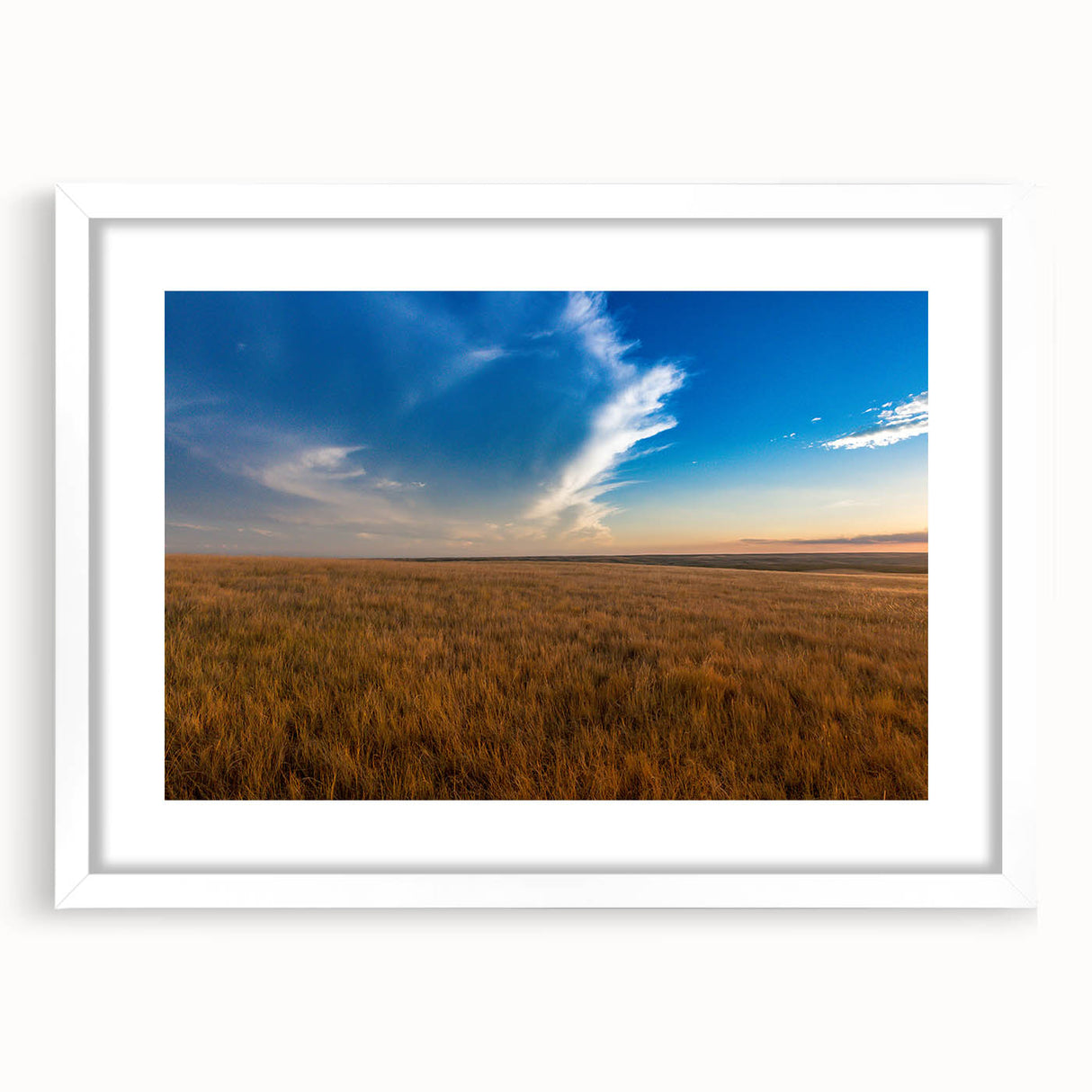 Abstract art print of South Dakota scenery in muted earth tones on a white framed canvas, suitable for dining room decor.