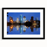 Abstract art print of Houston skyline in vibrant colors on a large framed canvas, suitable for living room decor.