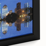 Close-up of a black wall art featuring a textured Houston skyline in vibrant colors on a framed canvas.