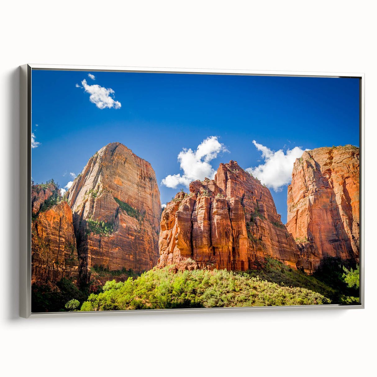 Framed canvas of a Zion National Park landscape painting, featuring vibrant colors and black accents.