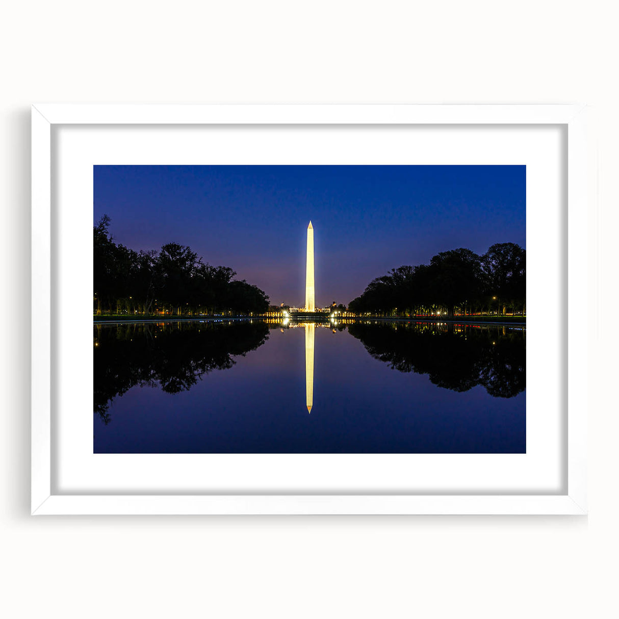 Abstract art print of Washington DC monuments in muted gray tones on framed white mat.
