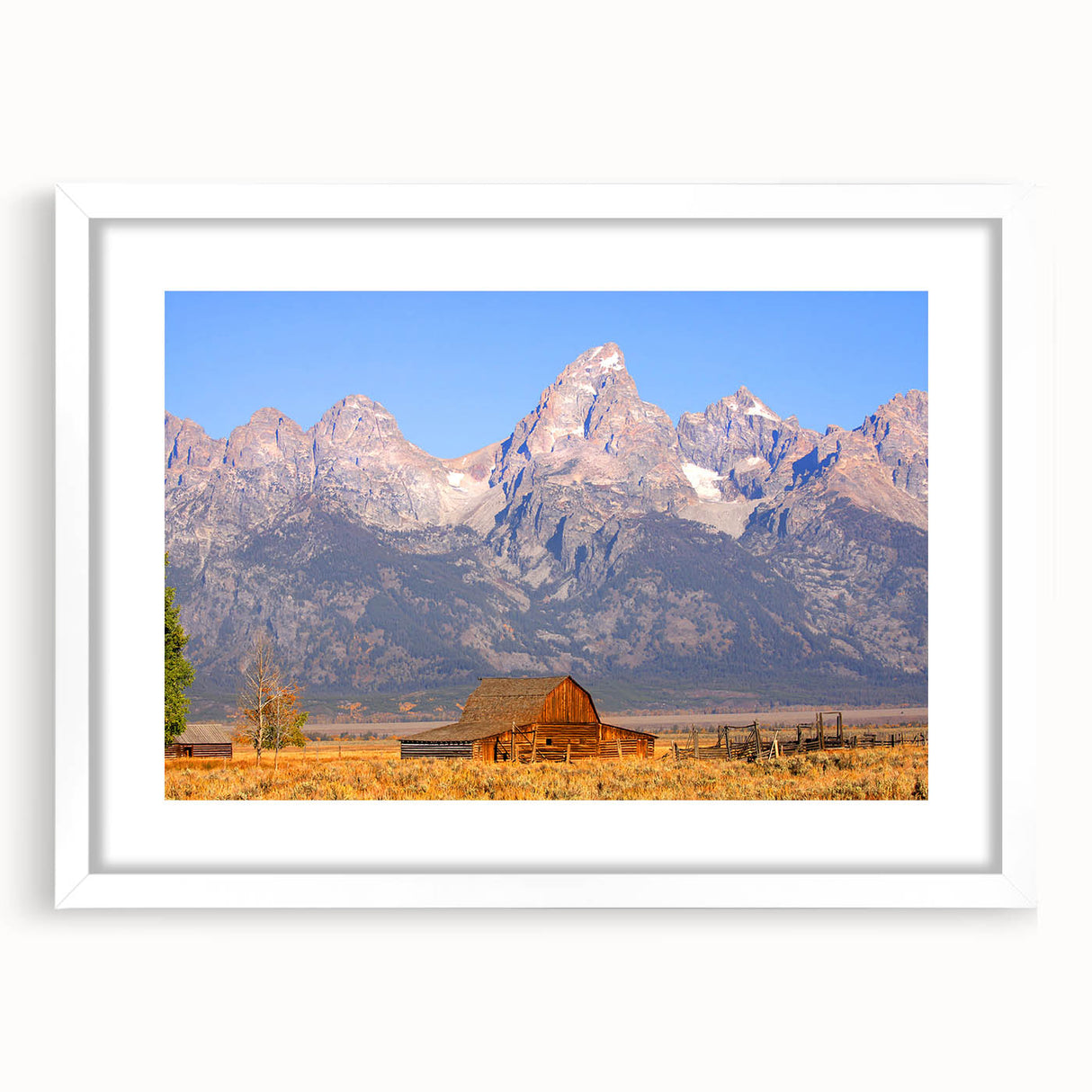 Abstract art print of the Grand Tetons in muted earth tones on a framed white mat, suitable for bedroom or dining room decor.
