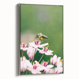 Framed canvas depicting a spring landscape with vibrant colors on a silver frame, suitable for living room decor.