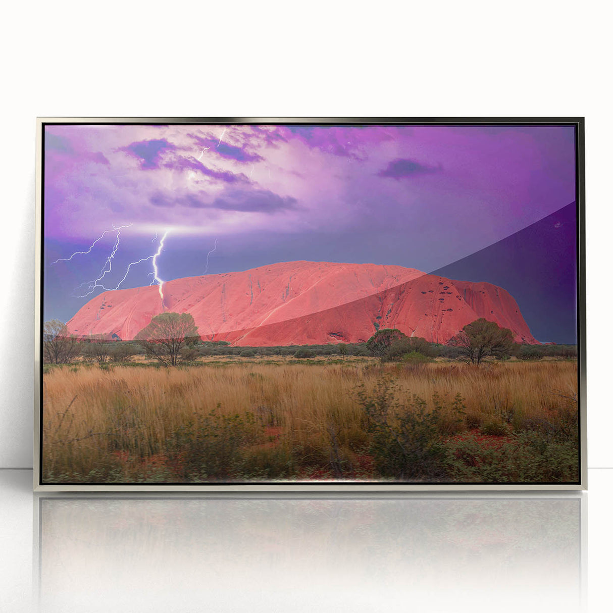 Acrylic print of Ayers Rock in muted earth tones, framed in silver, suitable as modern art wall decor.