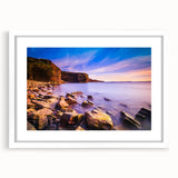 White-framed wall art of Newfoundland scenery in muted earth tones, ideal for dining room decor.