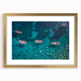 Abstract art print of a Caribbean scenery in muted blue and green tones, framed in gold, suitable for dining room decor.