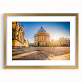 Abstract art print of Oxford scenery in muted earth tones, framed in gold, suitable for dining room decor.