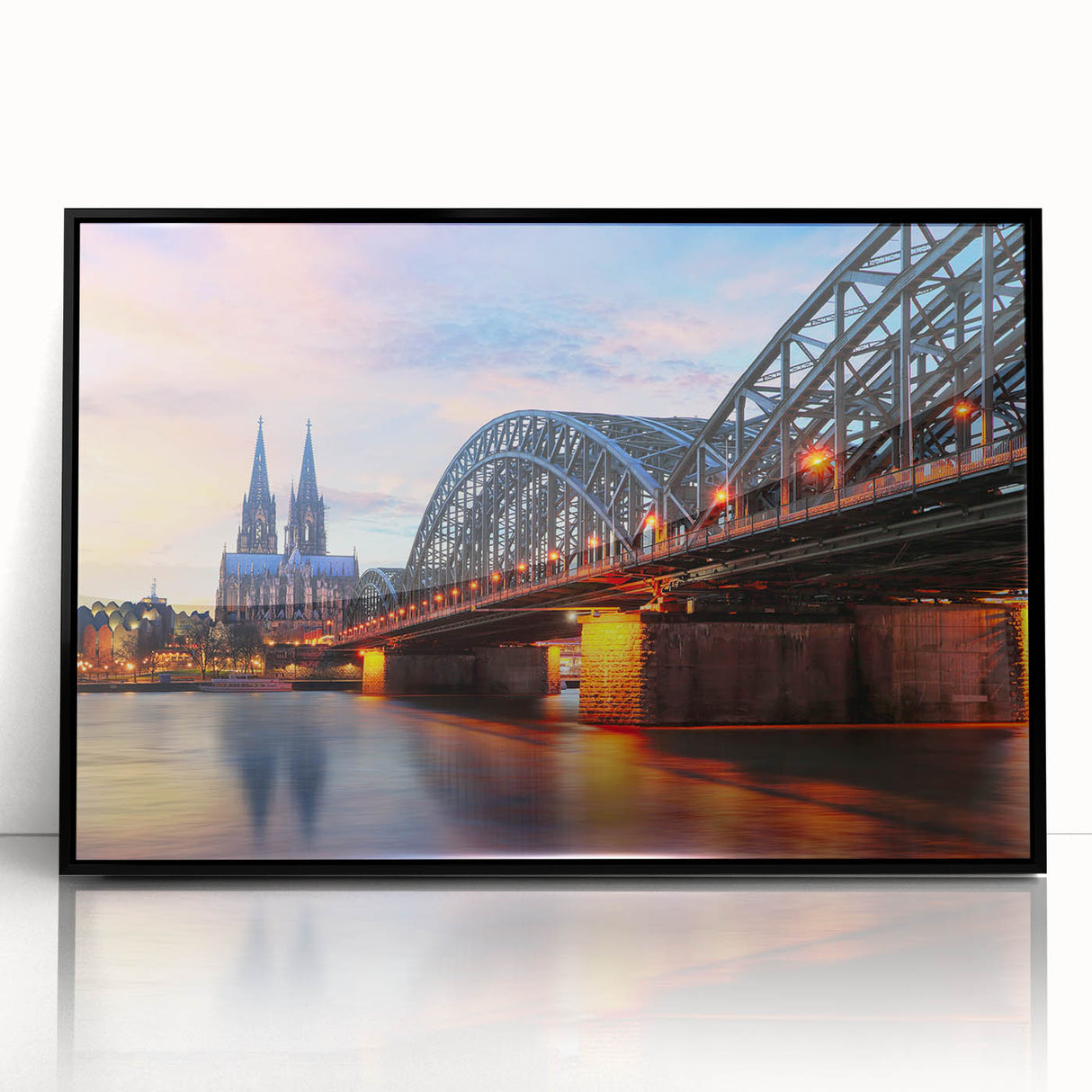 Large abstract wall art depicting a stylized European cityscape in muted gray and black tones, framed in black acrylic.