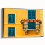 Framed canvas featuring a vintage-style landscape art painting of Portofino, Italy with colorful buildings and a black boat.
