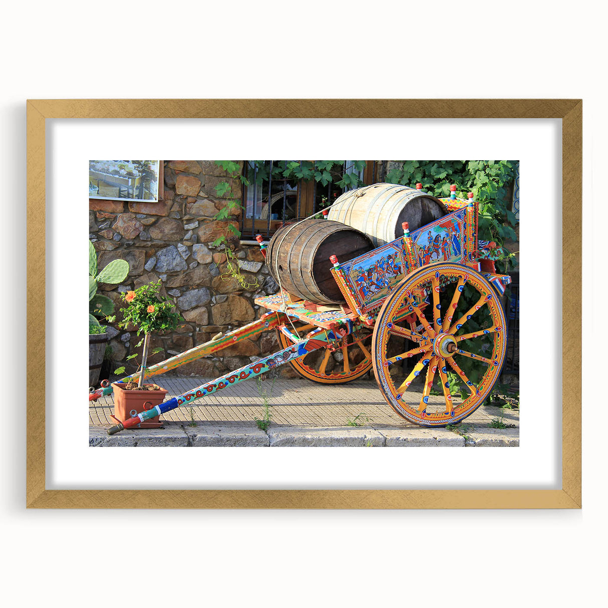 Abstract art print of Sicilian landscape in muted gold and green tones, framed with mat in a gold frame.