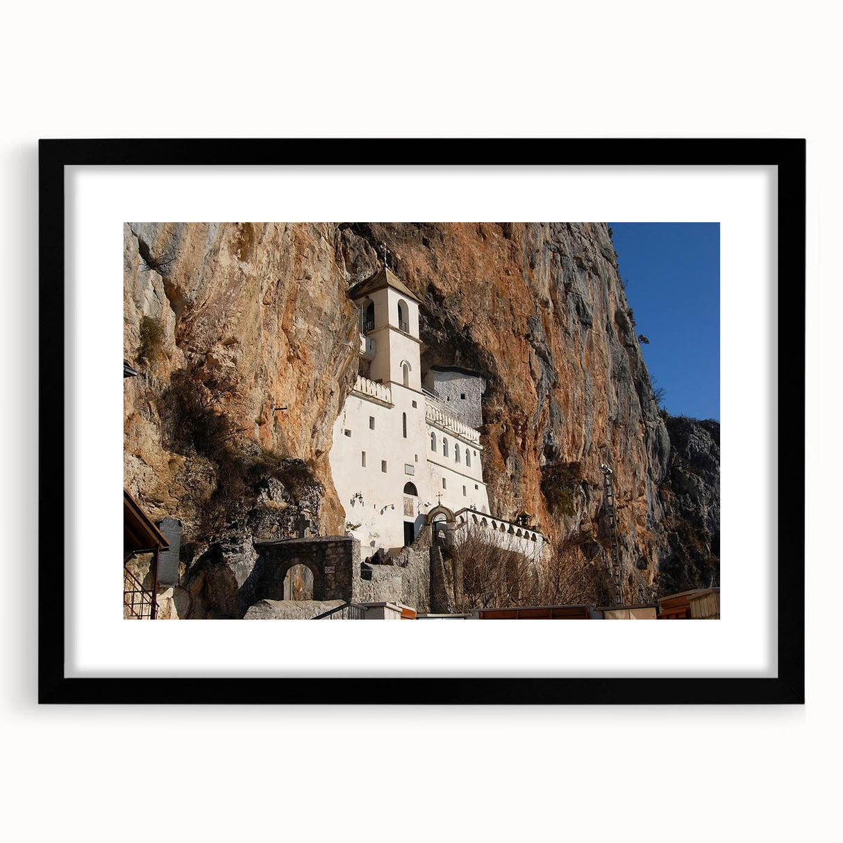 Abstract art print of a European scenery in vibrant colors, textured on a large black framed canvas.