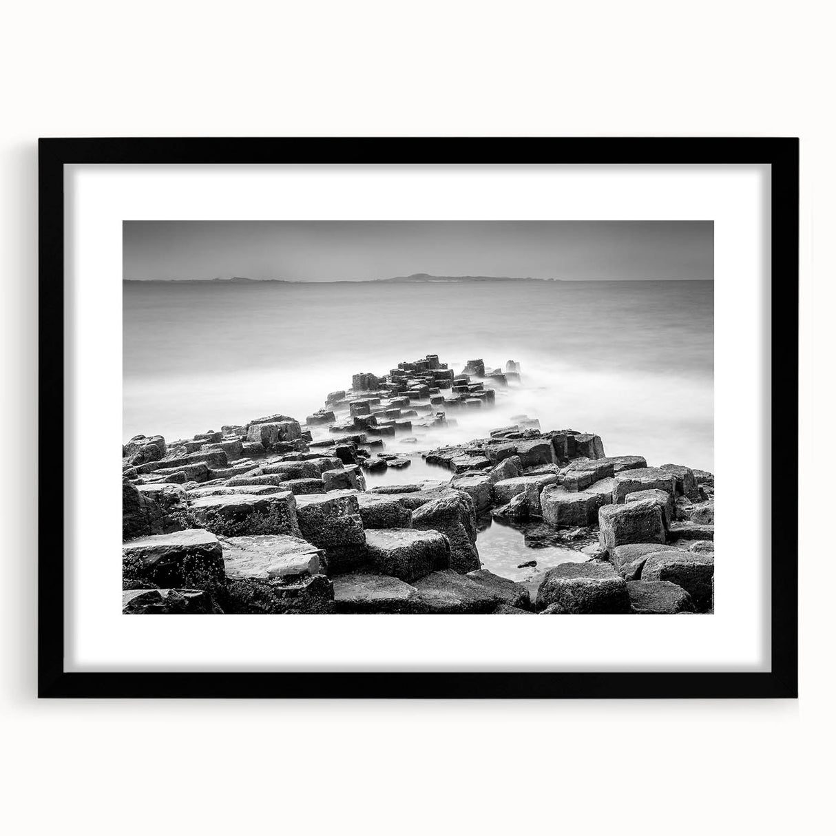 Abstract art print of a colorful, textured landscape on an extra large canvas, framed in black, ideal for living room decor.