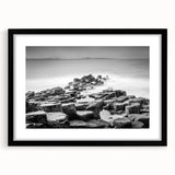 Abstract art print of a colorful, textured landscape on an extra large canvas, framed in black, ideal for living room decor.