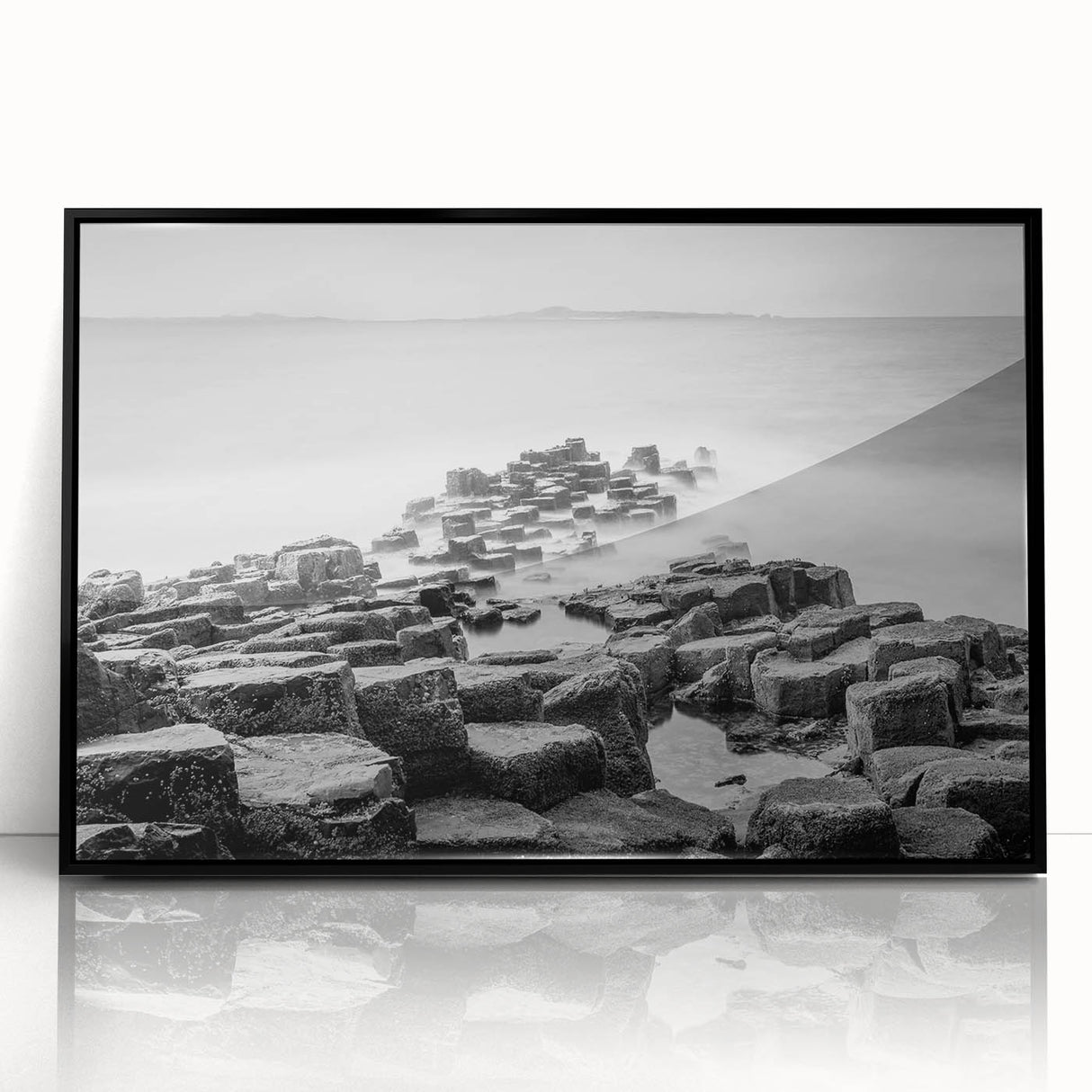 Large abstract wall art depicting a Northern Ireland landscape in muted green and blue tones, framed in black acrylic.