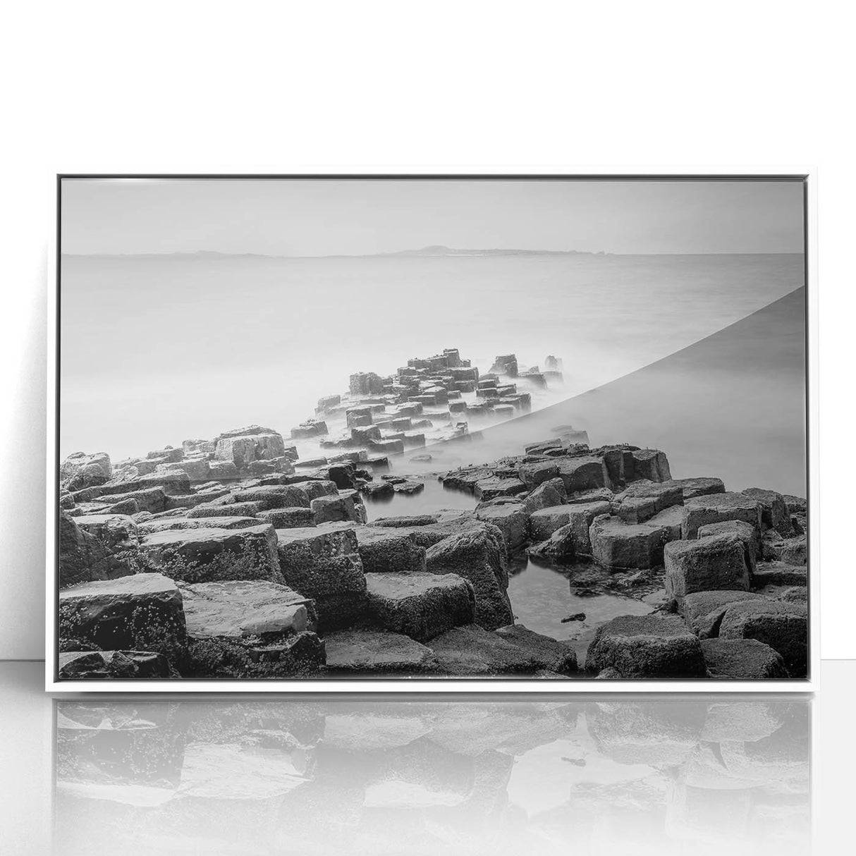 Mid-century modernist art depicting Northern Ireland's scenery in muted greens and blues on a white-framed acrylic.