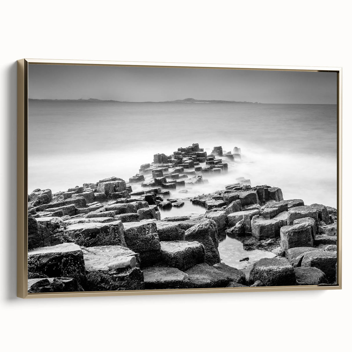 A vintage poster art depicting a black and white landscape of Northern Ireland on a framed canvas.