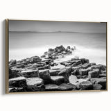 A vintage poster art depicting a black and white landscape of Northern Ireland on a framed canvas.