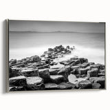 Framed canvas landscape art painting depicting the rugged coastline of Northern Ireland in muted earth tones.