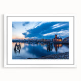 Abstract art print of a Welsh landscape in muted green and blue tones, framed with a white mat.