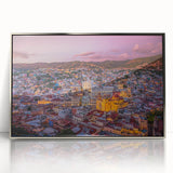 Mid-century modernist art depicting the colorful buildings of Guanajuato, Mexico, in a silver-framed acrylic.