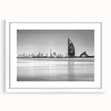 Abstract art print of Burj Al Arab in muted blue and gray, framed with a white mat.