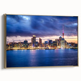 Framed canvas wall art featuring a vintage-style landscape painting of Auckland, with a dominant black and gold color scheme.