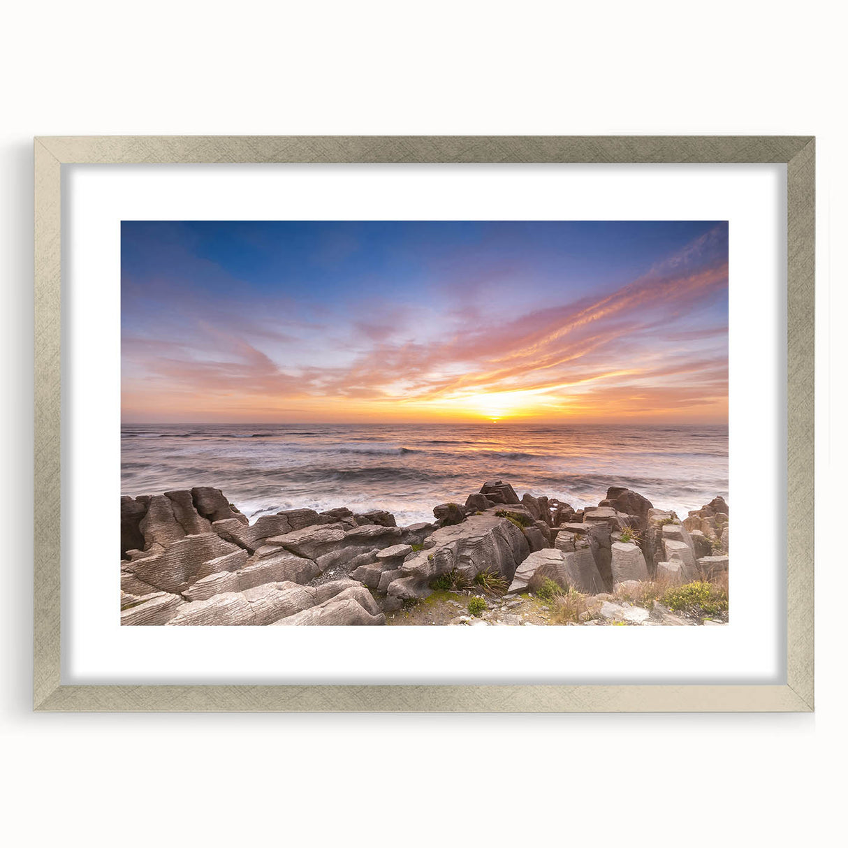 Textured art depicting abstract ocean waves in muted blue and gray tones, framed in silver, ideal for bedroom decor.