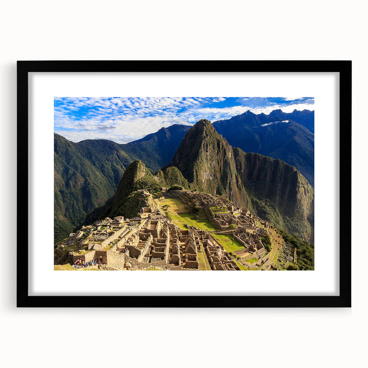 Colorful art print of Machu Picchu in vibrant greens and blues, framed in black.