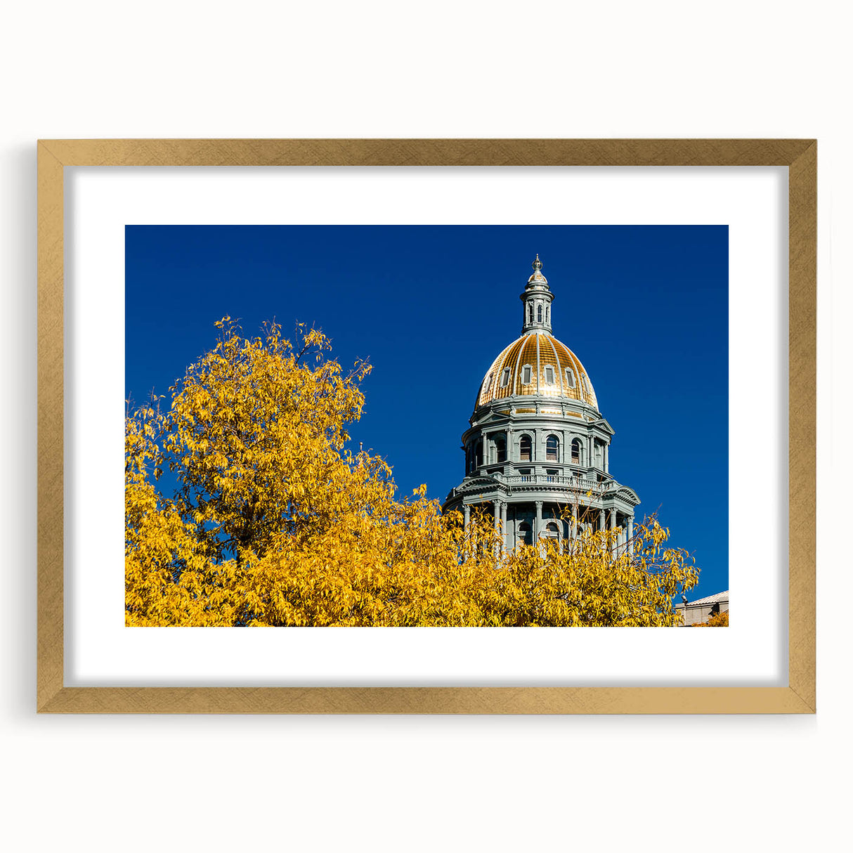 Extra large abstract art print of Denver skyline in textured gold frame, with muted earth tones, ideal for living room decor.