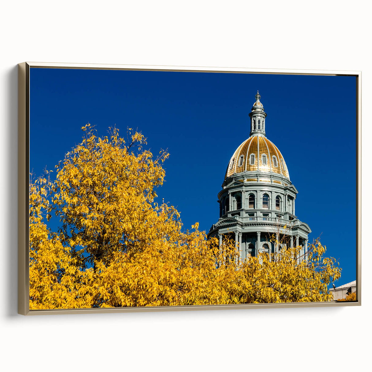 Framed canvas of Denver landscape in vintage poster style with gold and black color palette, ideal for bedroom wall art.