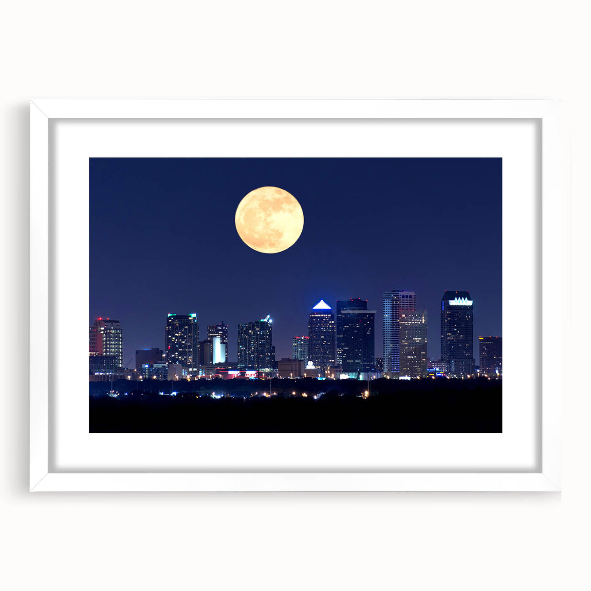 Abstract art print of Tampa skyline in muted blue and gray tones on a white framed mat, ideal for dining room decor.