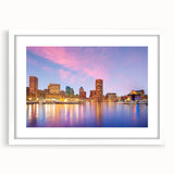 Abstract art print of Baltimore skyline in muted blue and gray tones on a framed white mat, ideal for dining room decor.