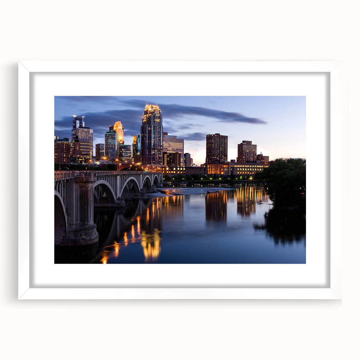 Abstract art print of Minneapolis skyline in muted gray and blue tones on a framed white mat, ideal for dining room decor.