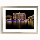 Textured abstract art print of Las Vegas skyline in silver frame, using muted gray tones, ideal for modern bedroom ambiance.