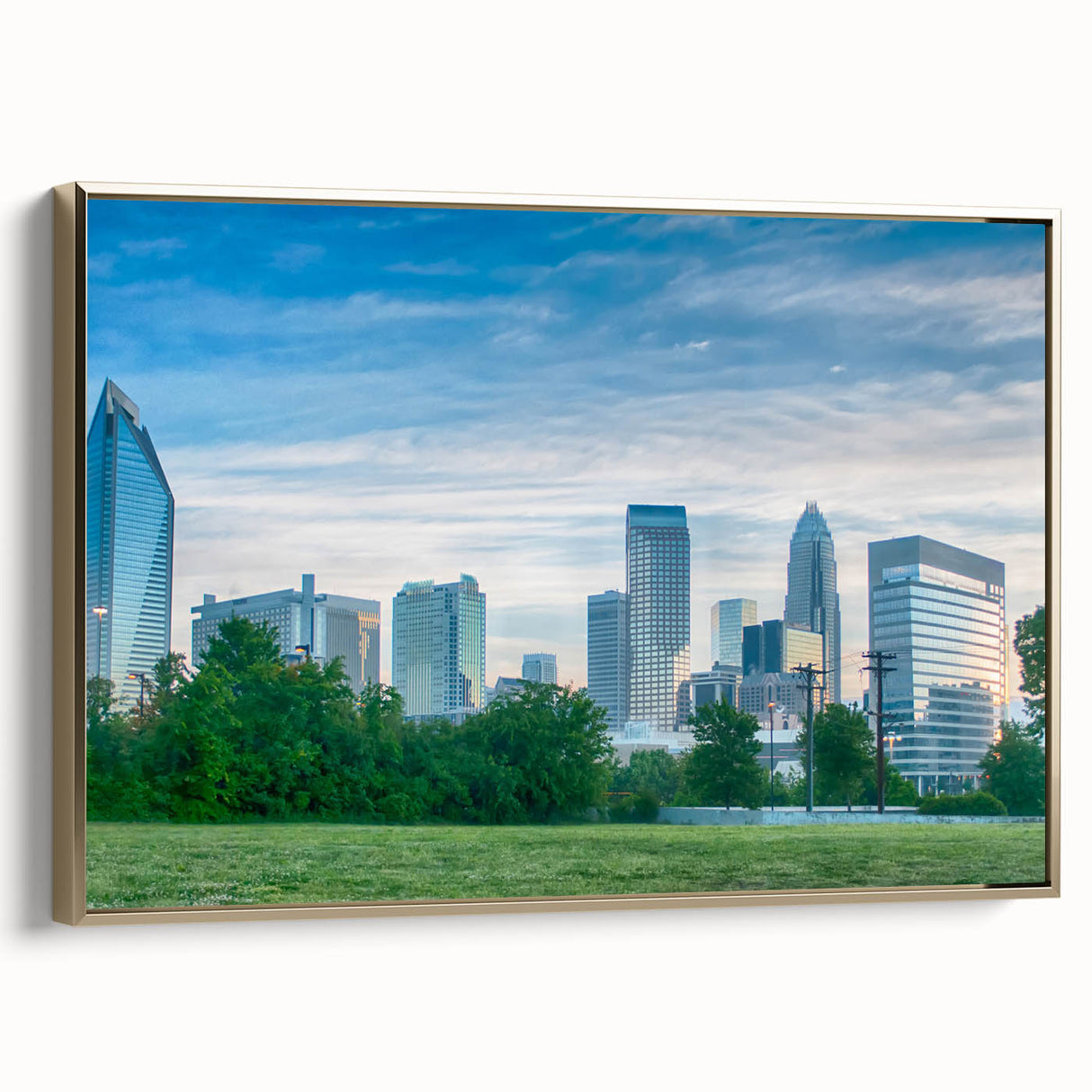 Framed canvas wall art featuring a black and white vintage poster of the Charlotte skyline, suitable for bedroom decor.