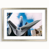 Textured art of abstract NYC skyline in muted gray, framed in silver, ideal for bedroom decor.