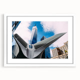 Abstract art print of NYC skyline in muted gray and blue tones, framed in white, ideal for dining room decor.