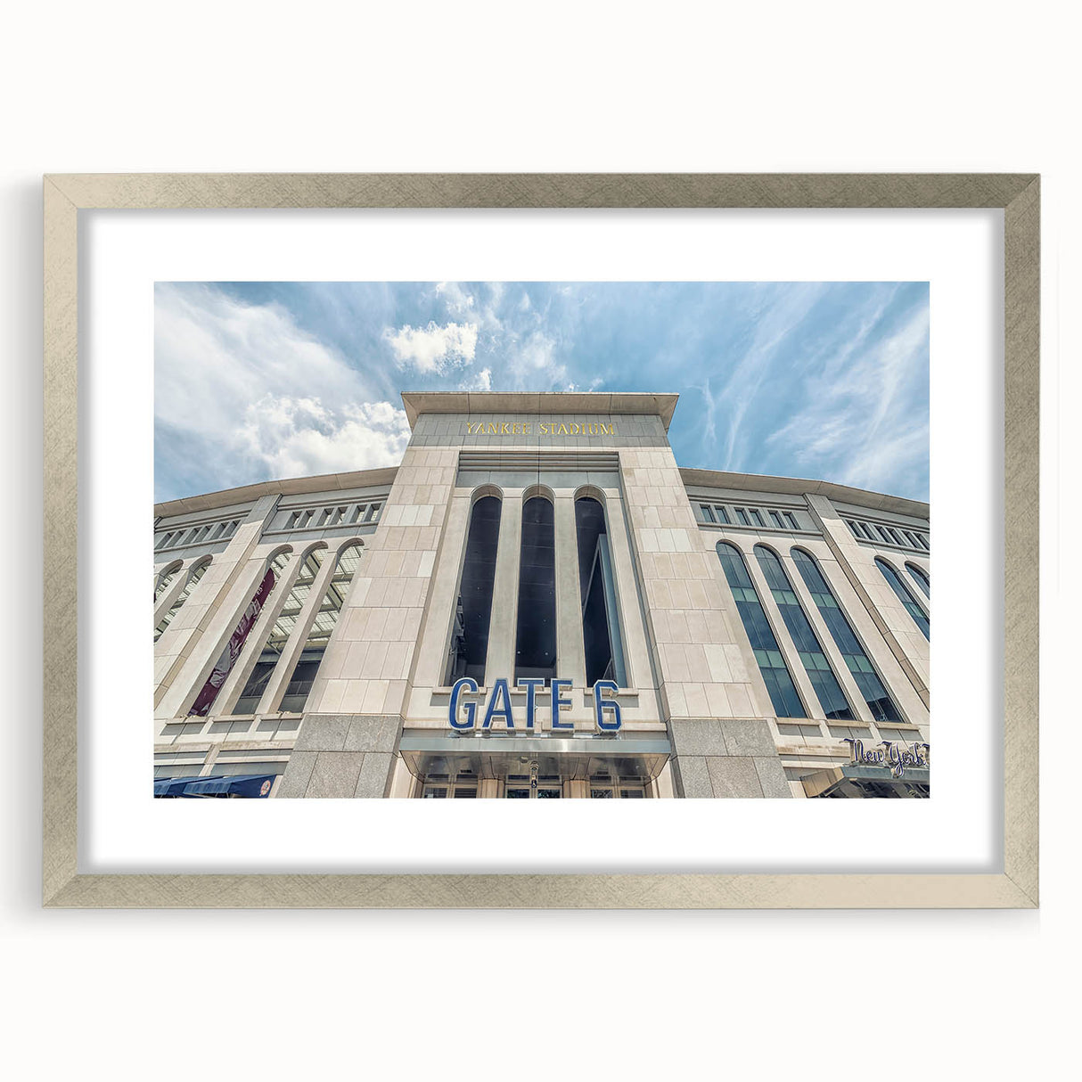Textured abstract art print of NYC skyline in muted gray and blue tones on a framed silver mat, suitable for bedroom decor.